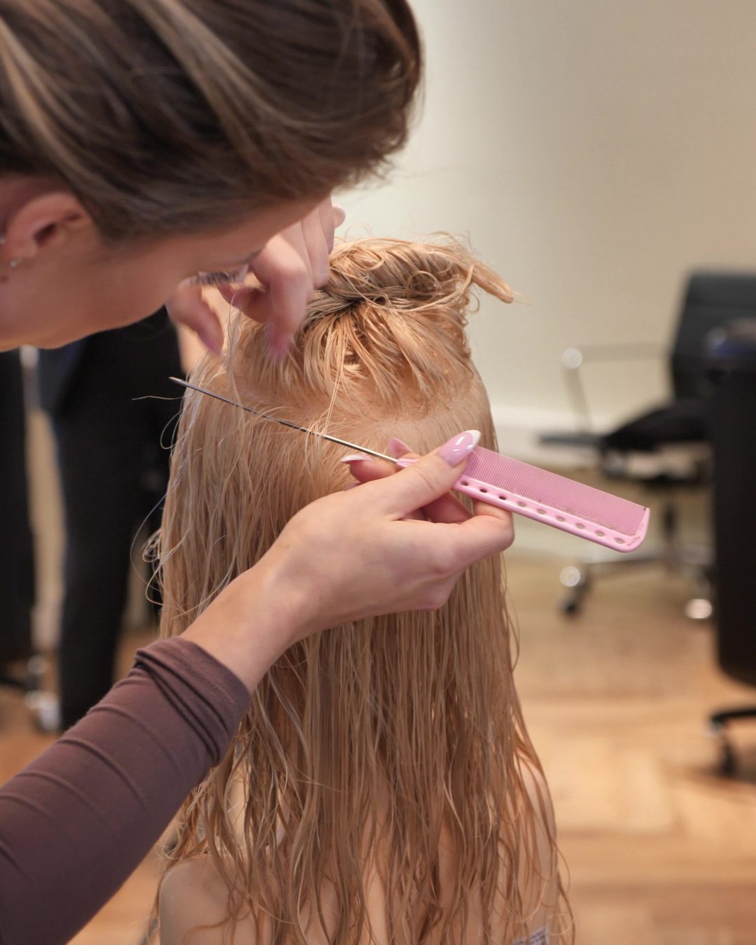 Hands-on sectioning with a pink tail comb during training at Balmain Hair Couture in Amsterdam