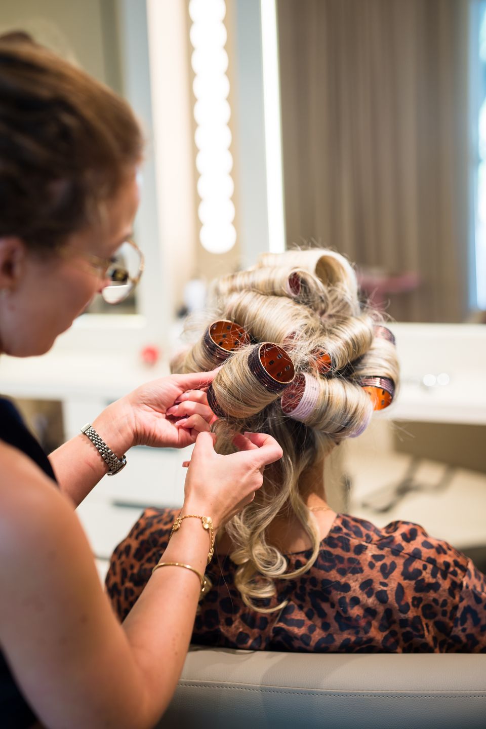 A roller set on bright blonde hair at a Studio Beige styling station
