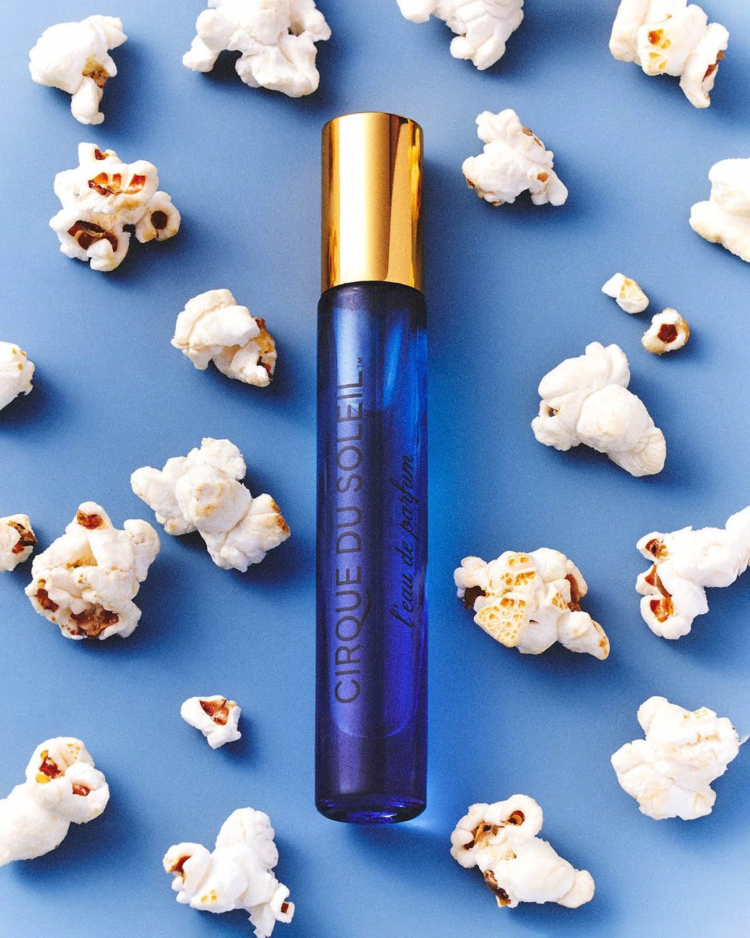 Cirque du Soleil L'eau de Parfum 10ml travel spray surrounded by popcorn