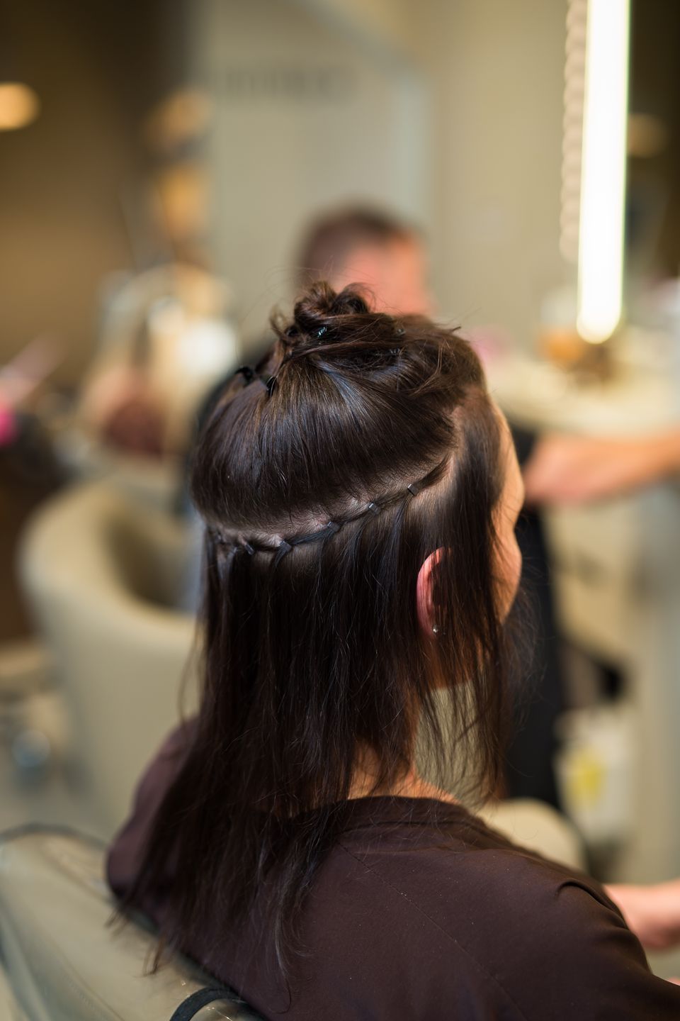 Hair sectioned with a clean row before extensions are placed