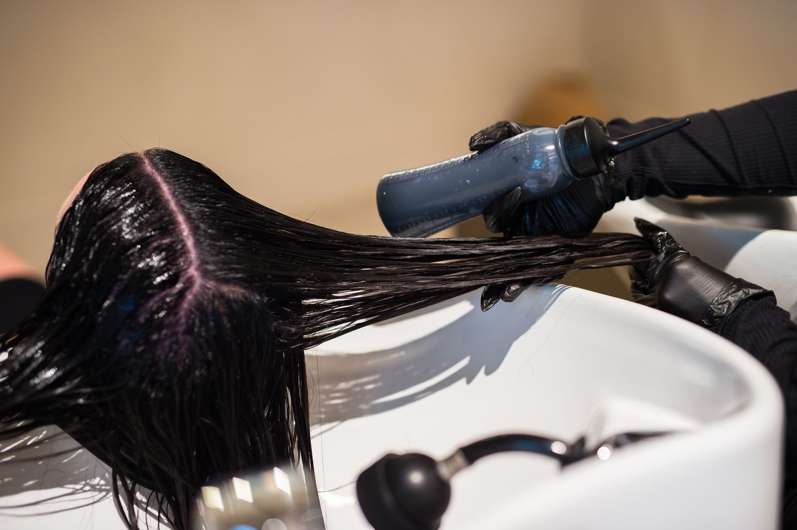 Color applied at the bowl to blend a client's own hair with her new extensions at Studio Beige