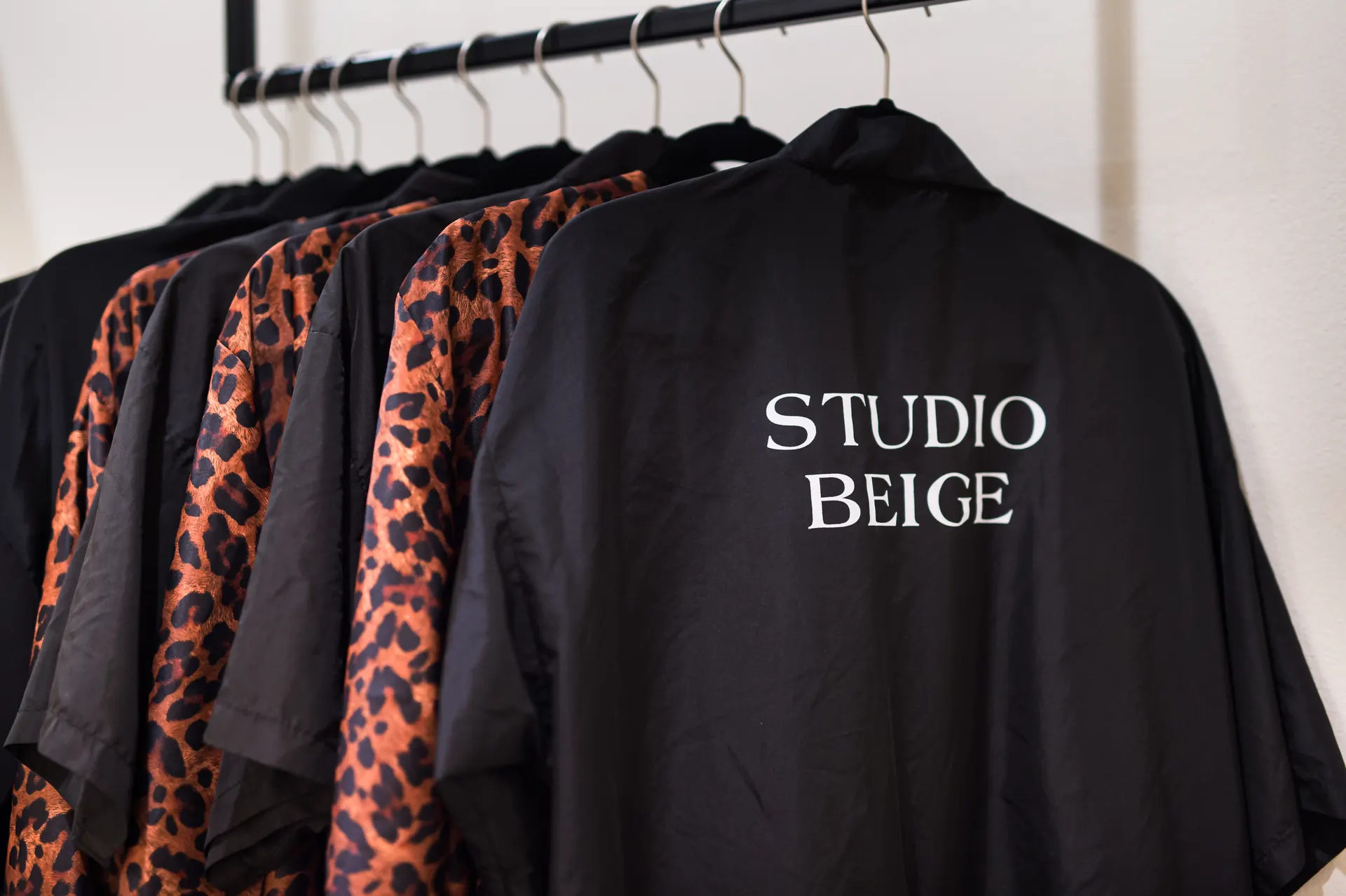 Studio Beige robes on a rack inside the atelier in Destin, Florida
