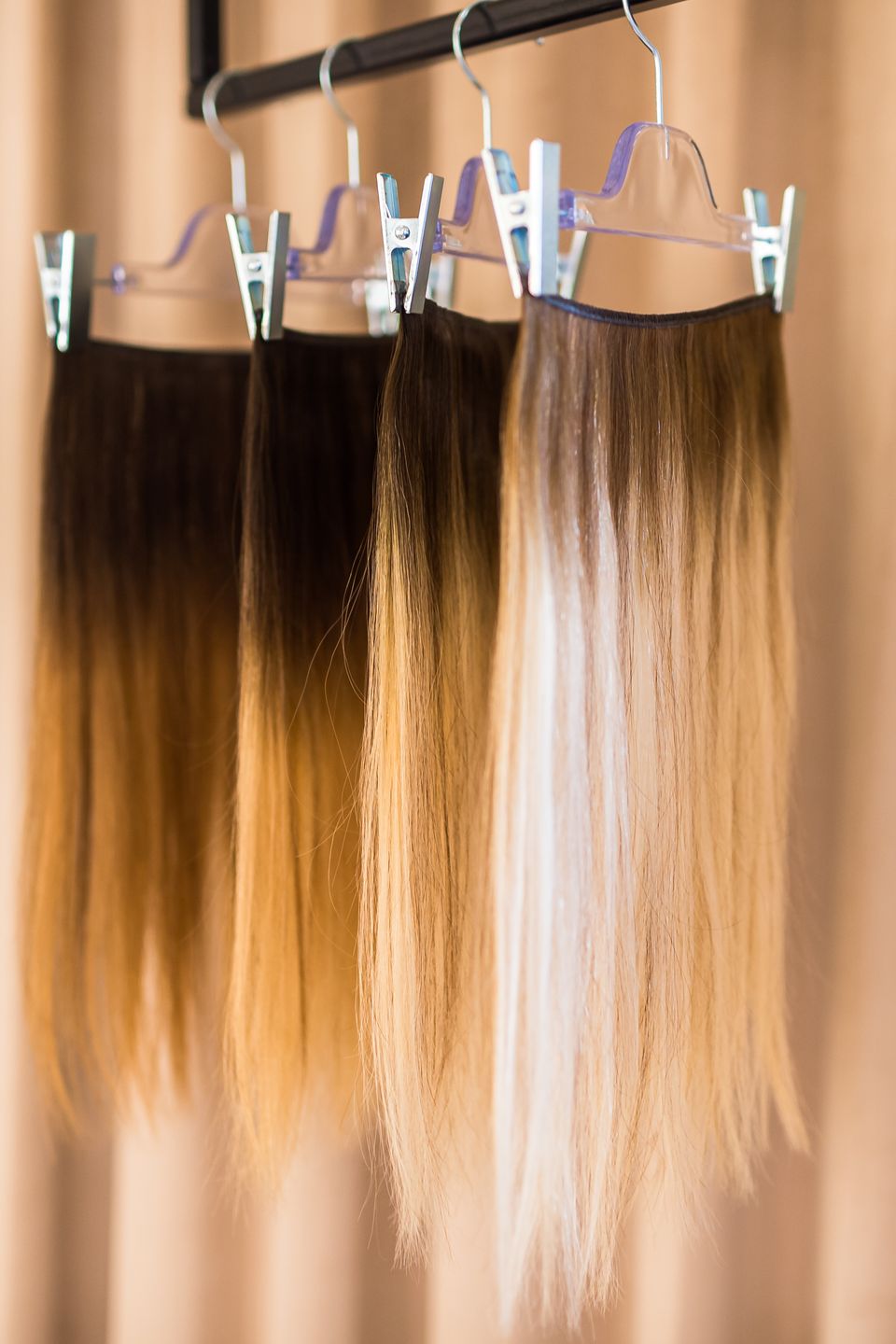 Extension wefts in a range of shades hanging at Studio Beige