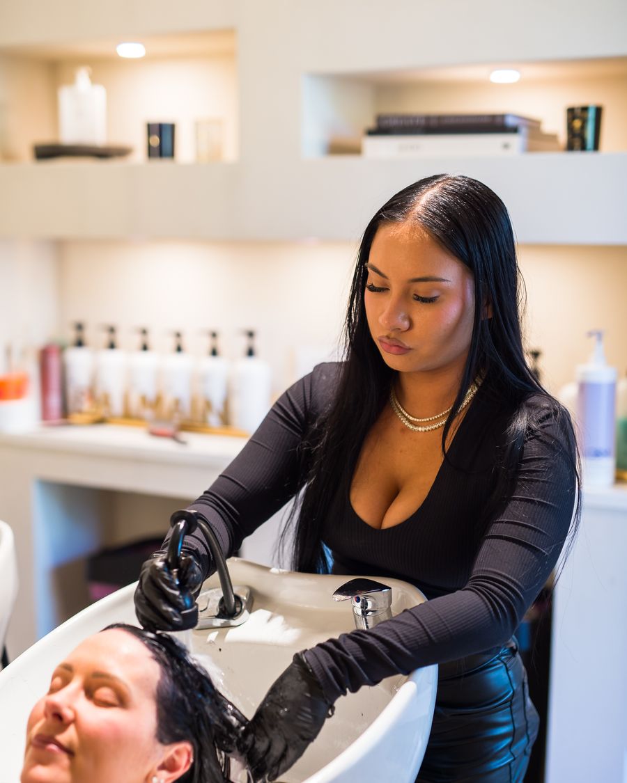 Faith Hall washing a client&rsquo;s hair at the Studio Beige wash bar