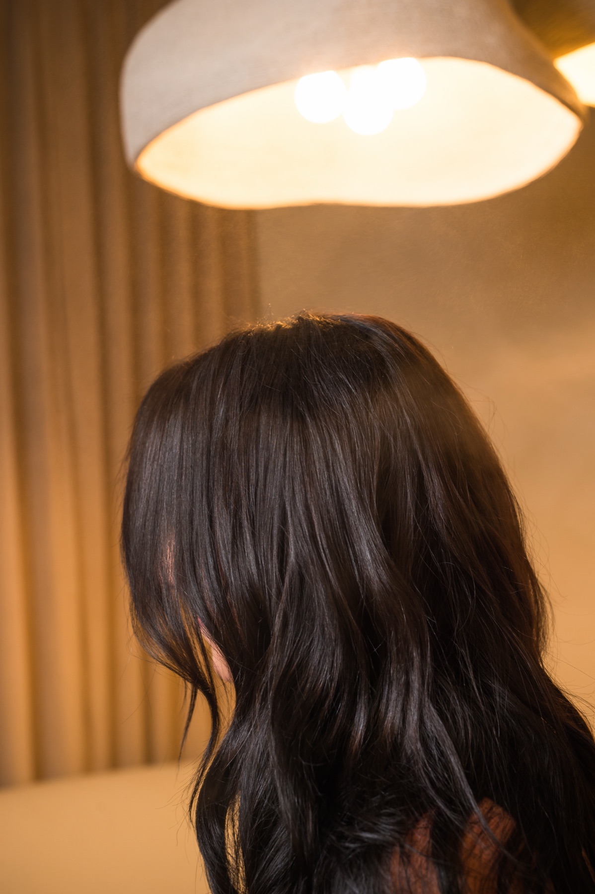 Glossy dark wavy hair extensions installed at Studio Beige, Emerald Coast